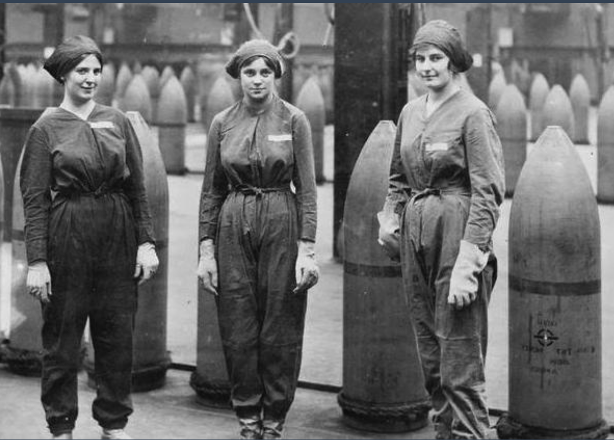 black and white photo of 3 women in boiler suits